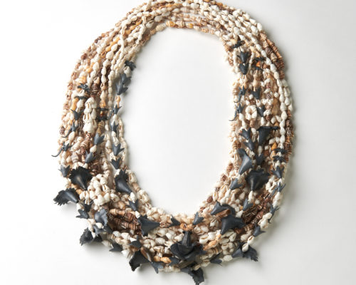 a large round necklace made of tiny shells